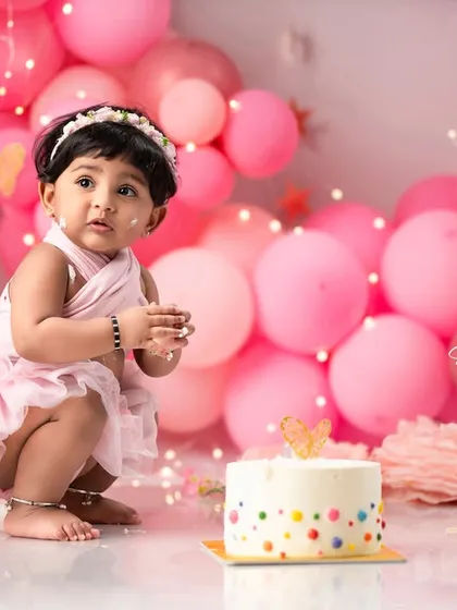A first birthday deserves a grand celebration. This luxury cake smash session features a custom cake and an elaborate balloon wall, all designed around a soft pink theme. I handle all the props and decor, so you can simply enjoy watching your little one have a wonderfully messy time.