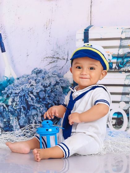 Ahoy, little sailor. Dressed in a classic sailor suit, this little one is ready to set sail on an ocean of cuteness.