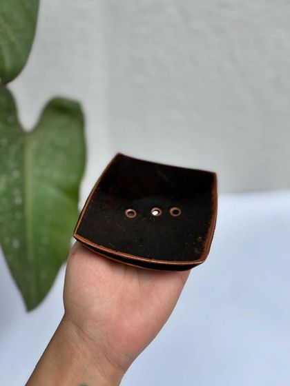 Our square soap dish in a glossy Tenmoku glaze. The three holes ensure proper drainage.