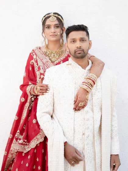 A beautiful couple portrait. Jagruti's bridal makeup looks stunning next to her groom, radiant and perfect for her special day.