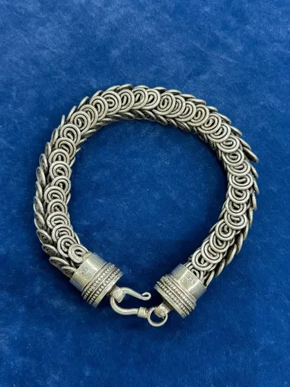 A full view of our unisex silver chainmail-style bracelet. The intricate, interlocking ring design gives it a substantial feel and a unique texture, making it a statement piece for anyone.