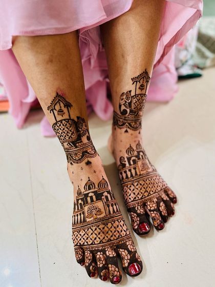 A beautiful foot design incorporating elephants and architectural domes, creating a royal theme that continues from the hands.