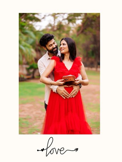 A lovely outdoor portrait where the couple holds a small, decorative box close to the baby bump. This prop adds a touch of mystery and elegance to their announcement.