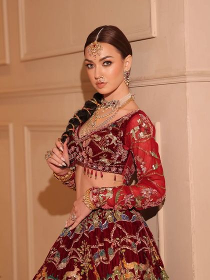 This shot highlights the unique braided hairstyle, a modern twist on a traditional bridal look.