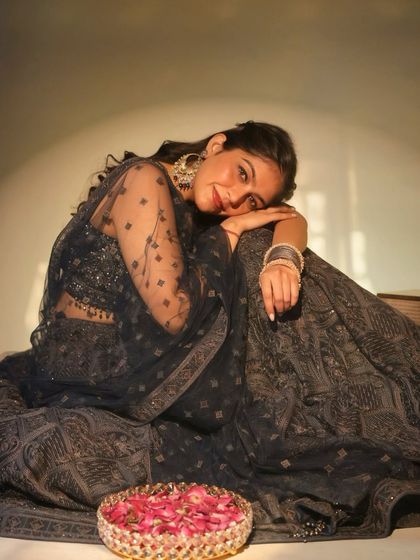 This dark grey lehenga gives off such a classic, old Bollywood vibe. I love creating thematic looks, and this one is perfect for a sangeet or reception with its intricate embroidery and sheer dupatta.
