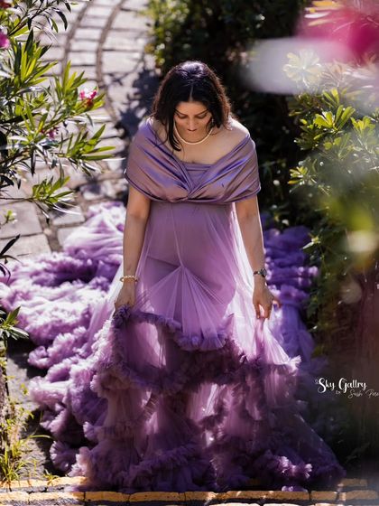 This shot from a destination shoot in Sri Lanka is pure regality. The mom-to-be descends a stone staircase, the lavender ruffled train of the gown cascading behind her.