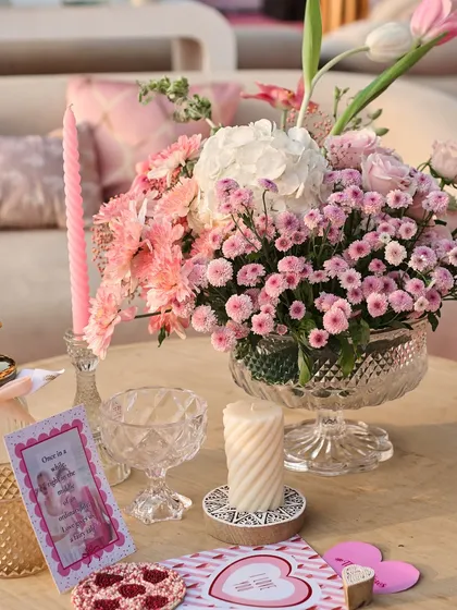 Another view of the personalized tablescape, showing how every element, from the candles to the flowers, was chosen to fit the romantic pink and white color scheme.