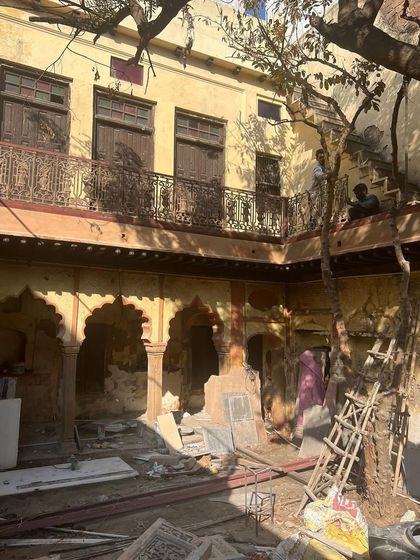 The courtyard mid-restoration, with scaffolding up and craftsmen at work, bringing the vision for a cultural hub to life.