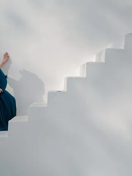 A moment of quiet reflection. This elegant solo maternity portrait showcases the beauty and strength of motherhood. We provide a selection of beautiful gowns to help you feel your best during the shoot.