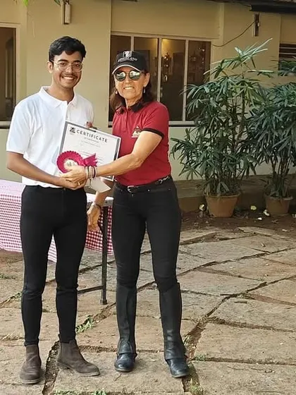 The EIRS Summer Camp is a fantastic opportunity for kids to immerse themselves in the world of horses. Here, a camper receives his certificate after a week of fun, learning, and riding.