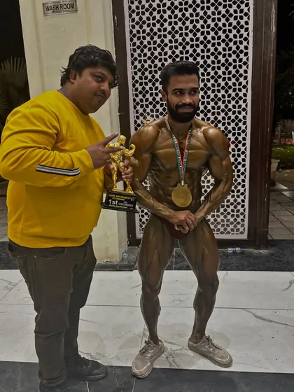Holding the trophy and medal. A proud moment for me as a coach, seeing my athlete's hard work being rewarded.