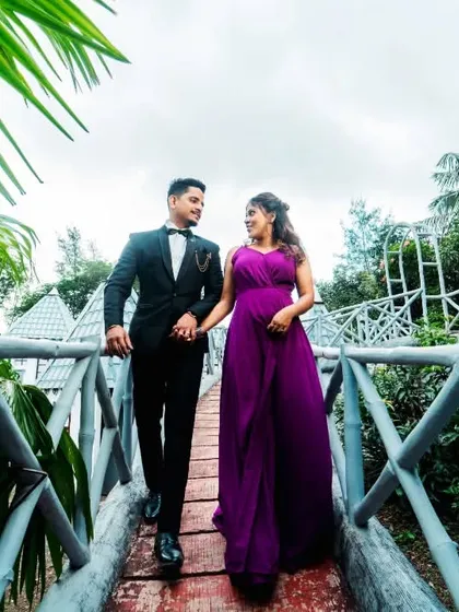 A romantic walk across a bridge at a creative photoshoot set. The leading lines of the bridge and the lush surroundings create a beautifully composed and dynamic image.