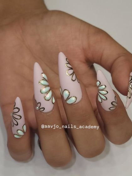 A close-up of the hand-painted floral design. The clean lines and the soft color palette make this a very sophisticated and modern take on floral nails.