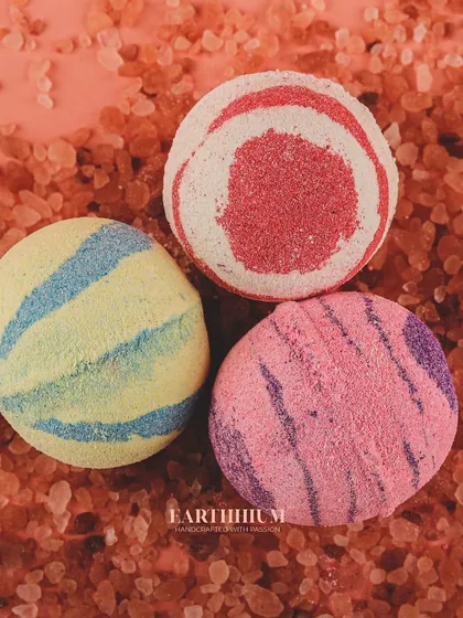 Transform your bath with my colorful and fragrant bath bombs. This overhead shot shows the different striped and solid designs, each ready to fizz and release soothing aromas.