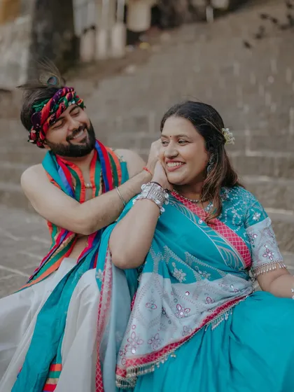 A playful and tender moment from a Radha-Krishna inspired pre-wedding shoot. His smile and her joyful expression perfectly capture the spirit of their love.