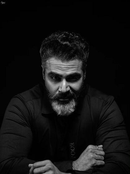 A direct and confident gaze. This black and white studio portrait is all about capturing a strong presence, with the lighting sculpted to define his features and create a timeless, masculine image.