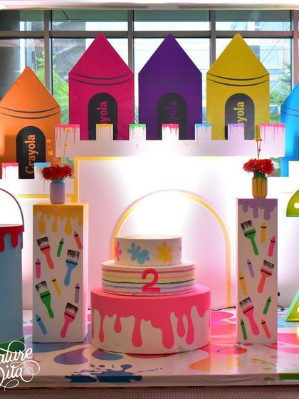 Welcome to the 'World of Color'. For this art-themed party, I designed a crayon castle backdrop, a paint-drip style cake display, and a light-up number '2', making it a creative paradise for a toddler.