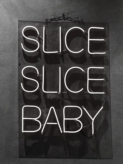 Slice, slice, baby! My neon sign has become an iconic part of the Camillo's vibe, perfect for that Instagram moment.