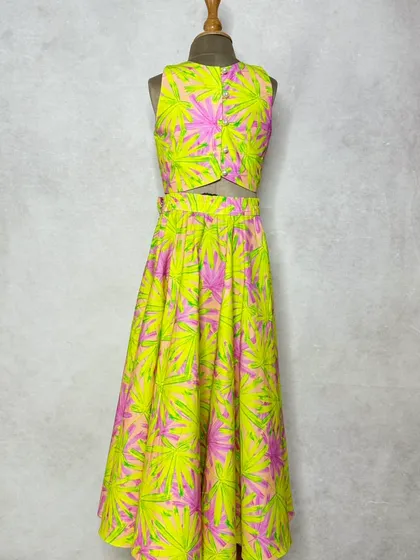 A vibrant neon leaf print lehenga made from thick, comfortable cotton. This is a fun, modern take on festive wear, with subtle embroidery on the crop top.