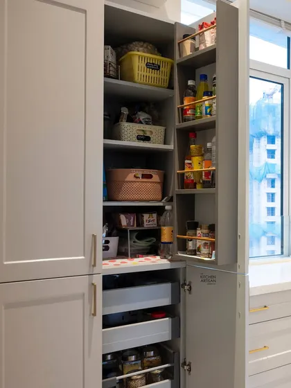 A well-organized pantry makes all the difference. Here, the pantry door is fitted with racks for spices and jars, maximizing storage and keeping frequently used items visible and easy to grab.