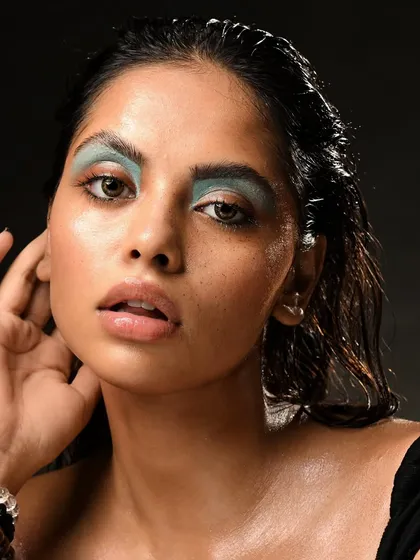 A direct and powerful portrait. The combination of the wet hair, dewy skin, and bold eye creates a memorable and high-fashion image.