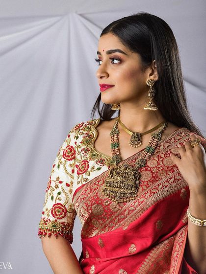 A beautiful three-quarter portrait of the bride, capturing the elegance of her pose and the richness of her traditional ensemble.