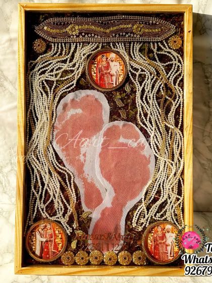 A full view of the 'griha pravesh' footprint preservation frame. It's a beautiful way to capture the moment a bride enters her new home for the first time.