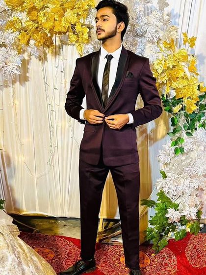 A client looking sharp and ready for an event in a custom-tailored wine-colored suit. This rich color is a great alternative to black or blue for making a stylish impression.