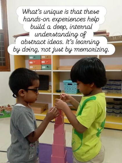 These hands-on experiences help build a deep, internal understanding of abstract ideas. Here, two children collaborate on building the Pink Tower, learning about dimension and sequence through teamwork. It's learning by doing, not by memorizing.
