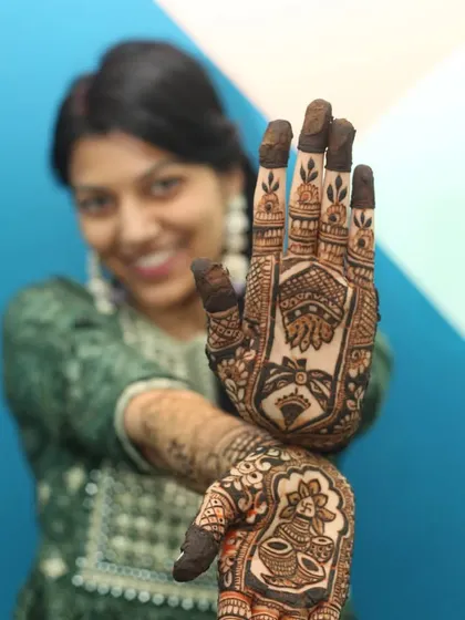 Capturing the details is just as important as the big picture. For this Mehandi shoot, I used a shallow depth of field to bring the intricate henna design on her hand into sharp focus, while keeping her smiling face softly in the background.