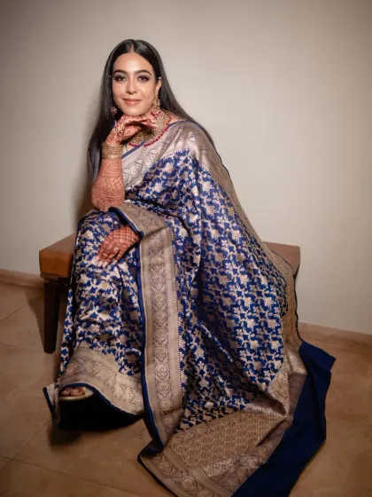 A full length shot of Sonia looking regal in her reception attire. The makeup was designed to complement the intricate work on her saree and her stunning gold jewelry.