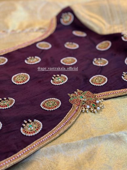 A closer look at the intricate back motif on the wine-colored blouse.