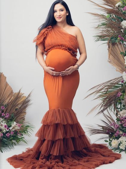 A full-length view of the Bronze gown. The form-fitting lycra bodice and dramatic tiered tulle skirt create a stunning mermaid silhouette.
