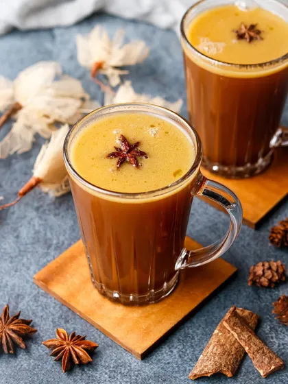 A warm and spicy hot toddy, styled with cinnamon sticks and star anise to evoke an autumnal feeling.