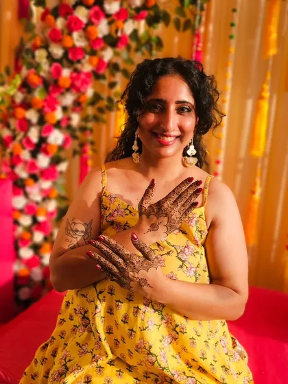 Seeing my clients happy is the best part of my job. Here is a beautiful client glowing at her mehendi ceremony, her hands adorned with a custom design that we created together for her special day.