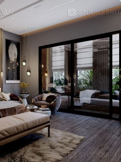 A wide view of the Alameda bedroom, showcasing the dark wood flooring, plush rug, and the large glass doors that lead to a private balcony.