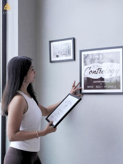 Pilates is a holistic transformation. Here, I'm arranging the inspirational art in my studio, which serves as a constant reminder of the mind, body, and spirit connection.