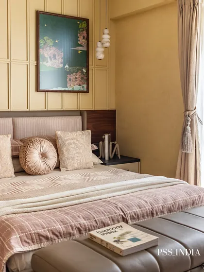 A beautifully styled bed with a mix of textures, from the quilted bedspread to the round, tufted cushion. A book resting on the end-of-bed bench invites you to relax and unwind.