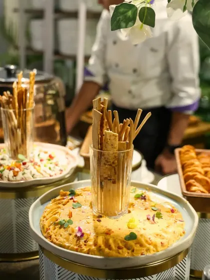 A beautifully layered presentation of dips and breadsticks on tiered stands. This not only looks appealing but also makes it easy for guests to serve themselves during a busy networking session.