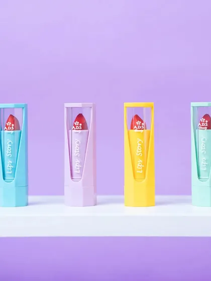 A clean, simple lineup of four pastel-colored lipsticks. This type of shot is great for showcasing different shades in a product line.