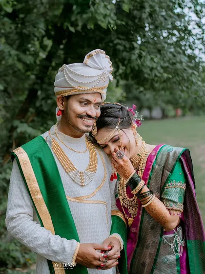 A candid and tender moment between a Maharashtrian couple. The bride's gentle lean and the groom's smile show their deep connection.