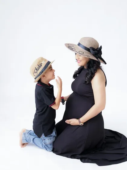 Welcoming a new sibling is a special journey for the whole family. I love capturing these sweet interactions, like this one where big brother is getting to know the baby bump.