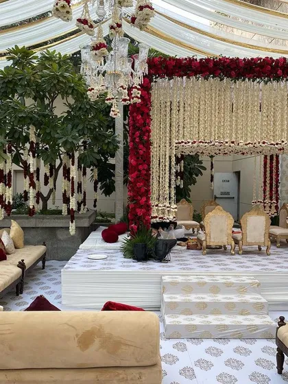 The sacred ceremony is the heart of the wedding, and its design should be breathtaking. This traditional mandap is framed with a profusion of red roses and cascading white florals, creating a space that is both opulent and deeply reverent for the wedding vows.
