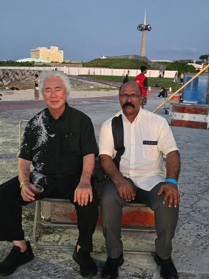 A moment of quiet conversation during the Okinawa tournament. Sharing insights with masters from different styles is always an enlightening experience.