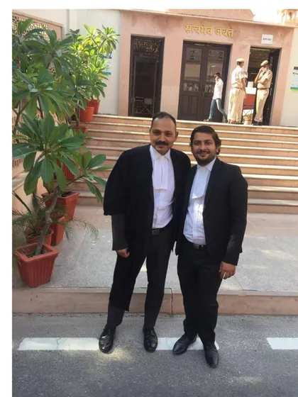 Posing with a junior colleague outside the court. Mentoring young lawyers is one of the most rewarding aspects of my career.