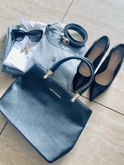 This flat lay shows how to elevate a monochrome grey and black outfit. By adding touches of gold through accessories like cufflinks and a belt buckle, and pairing with classic black pumps, the look becomes instantly more glamorous.