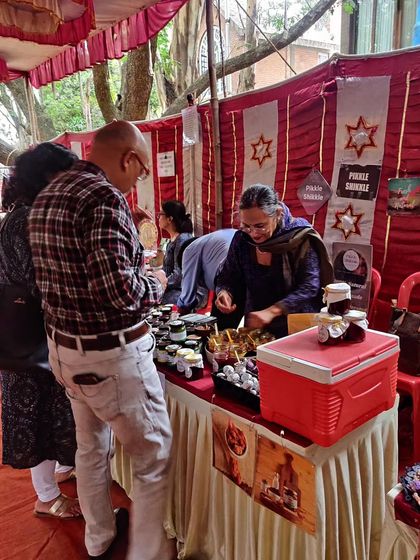 Here I am at a festive market, helping customers choose their favourite pickles and sweets. We always offer samples so you can find exactly what you like.