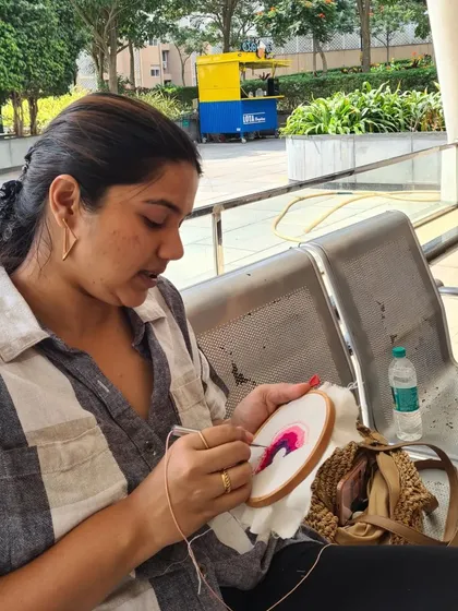 A participant fully engaged in her punch needle project. The repetitive motion is incredibly therapeutic and a great way to practice mindfulness and relieve stress.