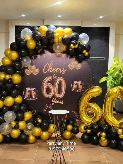 A 'Cheers to 60 Years' theme for a 60th birthday. The black and gold balloon arch and custom backdrop are perfect for celebrating this special milestone.
