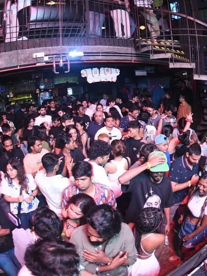 A wide shot of the entire club, packed from front to back.